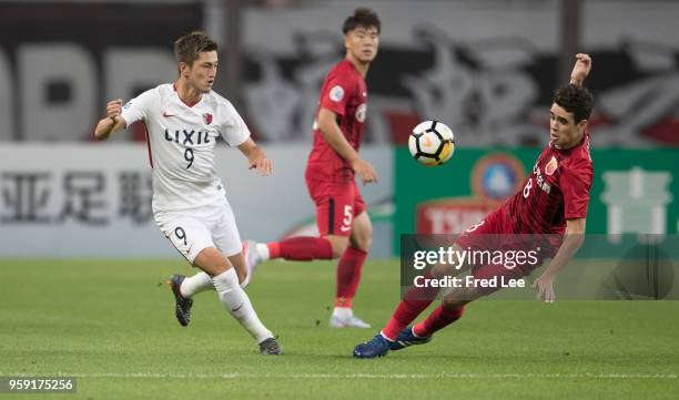 Oscar of Shanghai SIPG and Yuma Suzuki of Kashima Antlers in action during the AFC Champions League Round of 16 match between Shanghai SIPG v Kashima...