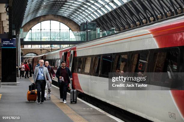 Passengers board a Virgin Trains East Coast train at Kings Cross Station on May 16, 2018 in London, England. East Coast trains are to be brought back...