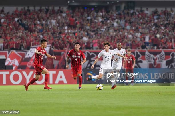 Kashima Midfielder Doi Shoma plays against Shanghai FC Defender He Guan during the AFC Champions League Round of 16 match between Shanghai SIPG v...