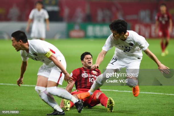 Hulk of Shanghai SIPG is challenged by Kashima Antlers players during the AFC Champions League Round of 16 second leg match between Shanghai SIPG and...