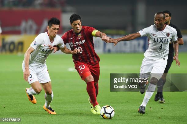 Hulk of Shanghai SIPG is challenged by Kashima Antlers players during the AFC Champions League Round of 16 second leg match between Shanghai SIPG and...