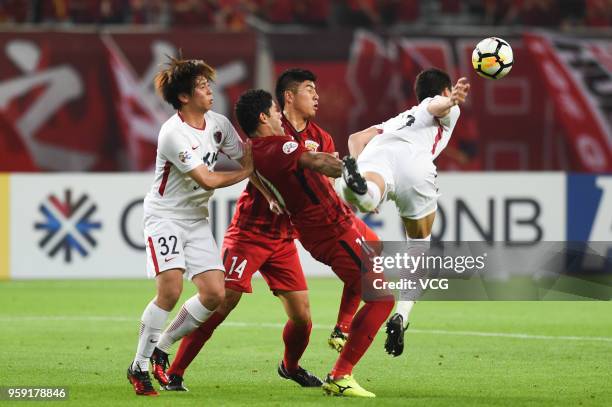 Hulk of Shanghai SIPG and Gen Shoji of Kashima Antlers compete for the ball during the AFC Champions League Round of 16 second leg match between...