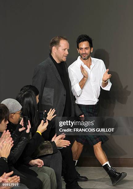 Studio Homme Dutch director Paul Helbers is applauded by designer Marc Jacobs at the end of his French label Louis Vuitton presentation during the...