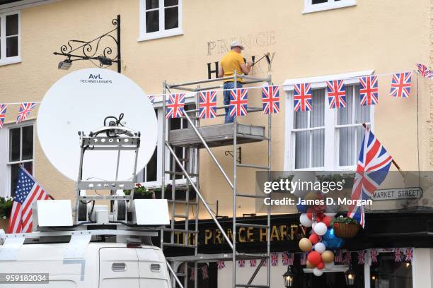 Painter painting the words Prince Harry on the wall of the Prince Harry pub near the castle on May 16, 2018 in Windsor, England. Preparations...