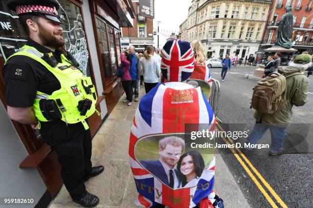 Police officer on duty smiles as a Royal fan passes him near the castle on May 16, 2018 in Windsor, England. Preparations continue in the town for...