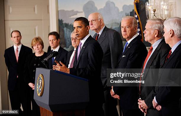 President Barack Obama, center, makes remarks on financial reform in the Diplomatic Reception Room of the White House in Washington, D.C., U.S., on...