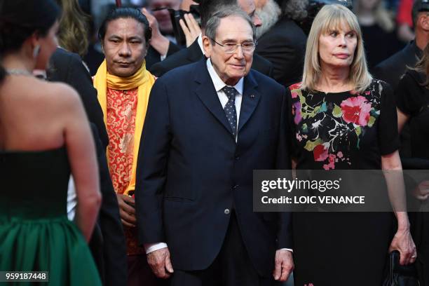 French director Robert Hossein and his wife Candice Patou arrive on May 16, 2018 for the screening of the film "Burning" at the 71st edition of the...