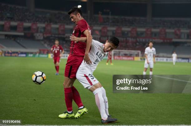 Yu Hai of Shanghai SIPG and Hiroki Abe of Kashima Antlers in action during the AFC Champions League Round of 16 match between Shanghai SIPG v Kashima...