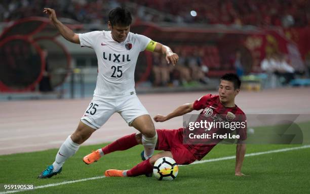 Wu Lei of Shanghai SIPG and Yasushi Endo of Kashima Antlers in action during the AFC Champions League Round of 16 match between Shanghai SIPG v...