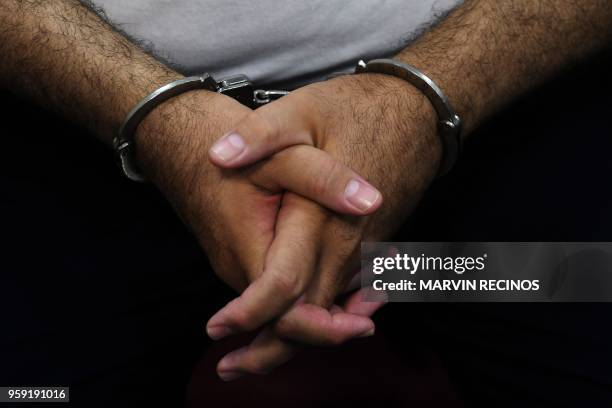 Detail of the hands of former Salvadoran President Elias Antonio Saca with handcuffs, taken as he waits, along with six of his collaborators, for the...