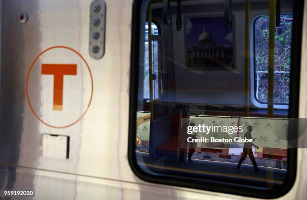 Commuters are reflected in the window of a new MBTA Orange Line car at Wellington Station in Medford, MA on May 15, 2018. The first new train is...