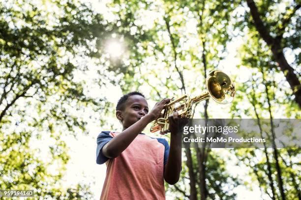 boy playing trumpet outdoors - trumpet 個照片及圖片檔