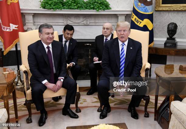 President Donald Trump speaks as the President of the Republic of Uzbekistan Shavkat Mirziyoyev listens during a meeting in the Oval Office of the...