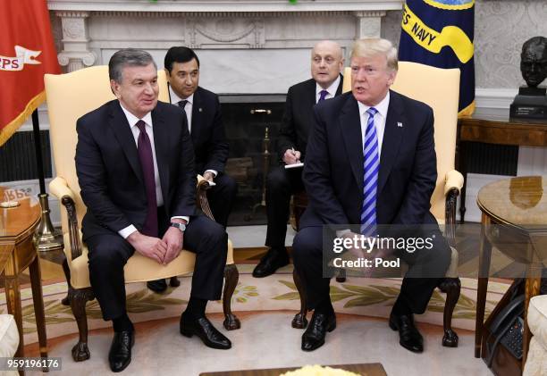 President Donald Trump speaks as the President of the Republic of Uzbekistan Shavkat Mirziyoyev listens during a meeting in the Oval Office of the...