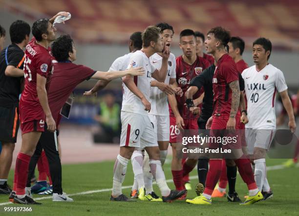 Yuma Suzuki of Kashima Antlers and Shi Ke of hanghai SIPG clash during the AFC Champions League Round of 16 match between Shanghai SIPG v Kashima...