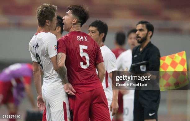 Yuma Suzuki of Kashima Antlers and Shi Ke of hanghai SIPG clash during the AFC Champions League Round of 16 match between Shanghai SIPG v Kashima...