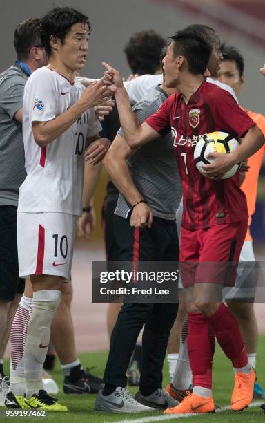 Mu Kanazaki of Kashima Antlers clash during the AFC Champions League Round of 16 match between Shanghai SIPG v Kashima Antlers at the Shanghai...