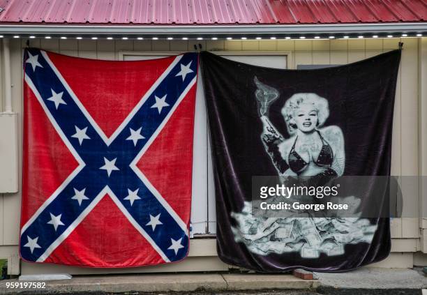 Marilyn Monroe and Confederate flag beach blankets hang outside a Maggie Valley gift shop on May 11, 2018 near Cherokee, North Carolina. The Great...