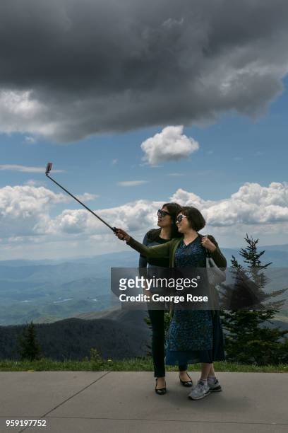 Tourists visiting Clingmans Dome, a major scenic viewing point near the Appalachian Trail, take a selfie on May 11, 2018 near Cherokee, North...