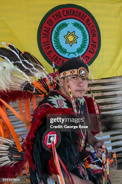 Native American in full head dress poses for pictures along the highway on May 11, 2018 in Cherokee, North Carolina. Located near the entrance to...