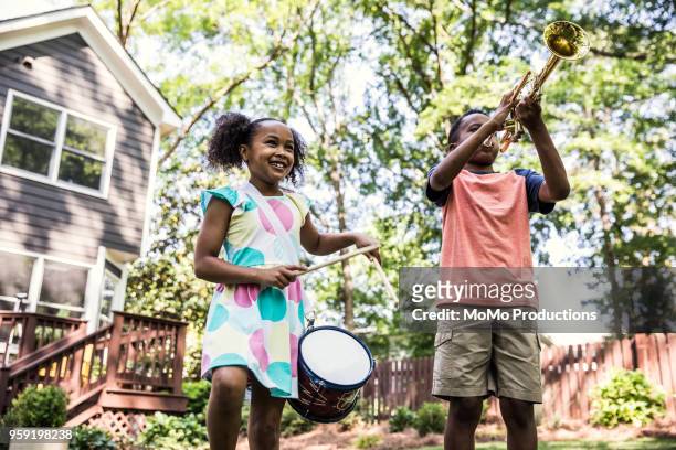 children playing instruments and marching outdoors - child marching stock pictures, royalty-free photos & images