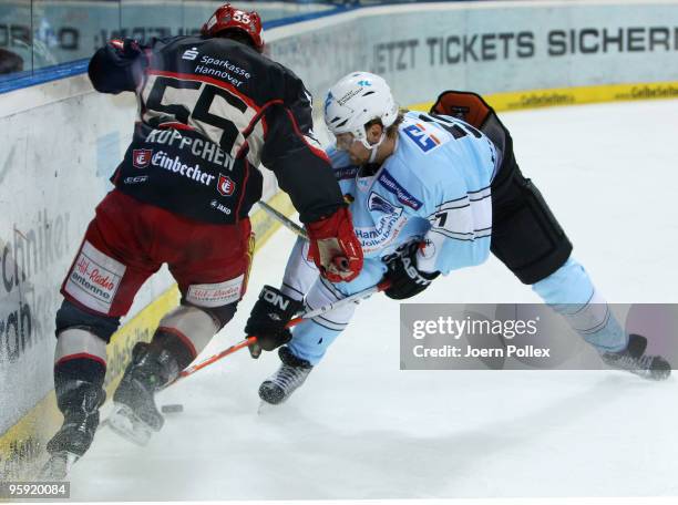 Thomas Pielmeier of Hamburg and Patrick Koeppchn of Hannover fight for the puck during the DEL match between Hamburg Freezers and Hannover Scorpions...