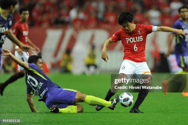 Felipe Silva of Sanfrecce Hiroshima and Wataru Endo of Urawa Red Diamonds compete for the ball during the J.League Levain Cup Group C match between...