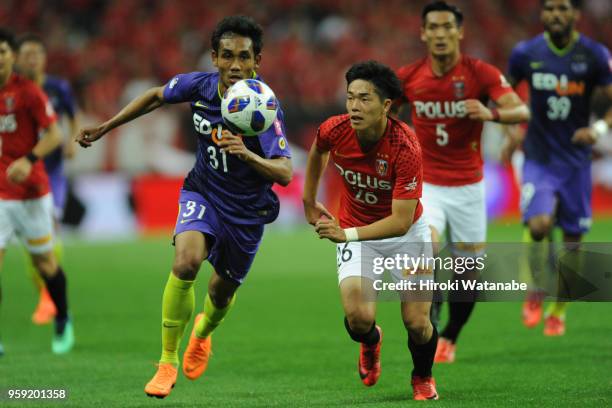 Teerasil of Sanfrecce Hiroshima and Takuya Ogiwara of Urawa Red Diamonds compete for the ball during the J.League Levain Cup Group C match between...