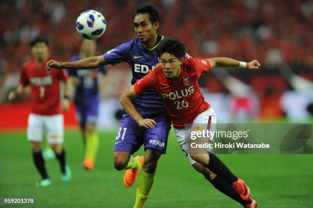 Teerasil of Sanfrecce Hiroshima and Takuya Ogiwara of Urawa Red Diamonds compete for the ball during the J.League Levain Cup Group C match between...