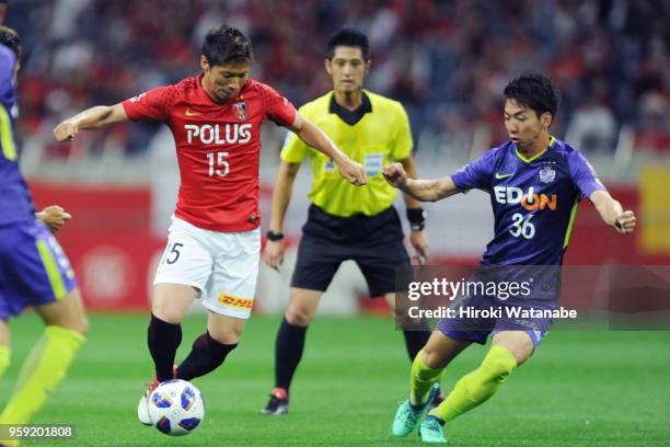 Kazuki Nagasawa of Urawa Red Diamonds and Hayao Kawabe of Sanfrecce Hiroshima compete for the ball during the J.League Levain Cup Group C match...