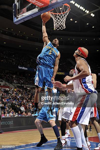 Marcus Thornton of the New Orleans Hornets dunks against Charlie Villanueva of the Detroit Pistons during the game at the Palace of Auburn Hills on...