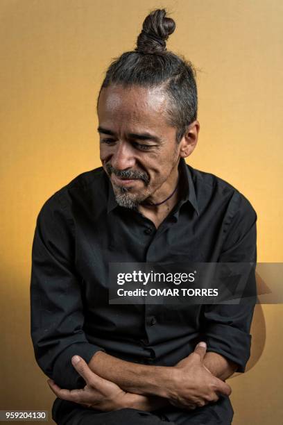 Mexican Ruben Albarran, member of "Cafe Tacvba" rock group, poses for pictures during an interview in Mexico City on April 18, 2018.