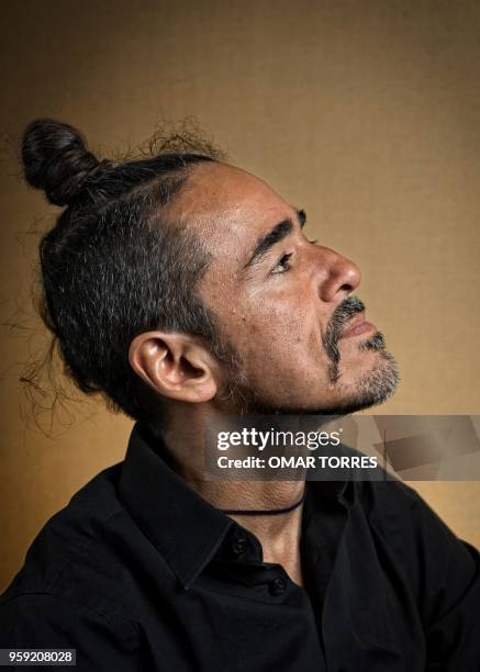 Mexican Ruben Albarran, member of "Cafe Tacvba" rock group, poses for pictures during an interview in Mexico City on April 18, 2018.