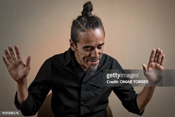 Mexican Ruben Albarran, member of "Cafe Tacvba" rock group, poses for pictures during an interview in Mexico City on April 18, 2018.