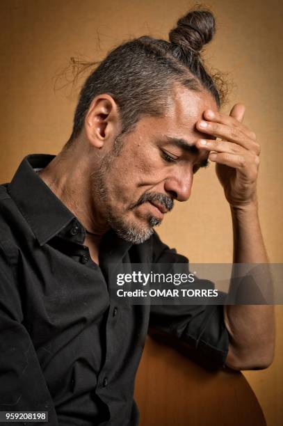 Mexican Ruben Albarran, member of "Cafe Tacvba" rock group, poses for pictures during an interview in Mexico City on April 18, 2018.