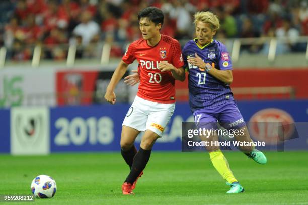 Tadanari Lee of Urawa Red Diamonds and Kazuaki Mawatari of Sanfrecce Hiroshima compete for the ball during the J.League Levain Cup Group C match...