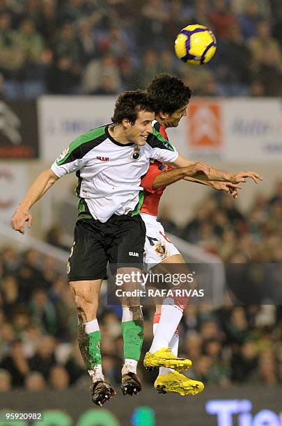 Racing's Christian Fernandez vies with Osasuna's Iranian Masoud Shojaei during the Spanish King's Cup quarter finals match at Sardinero stadium in...