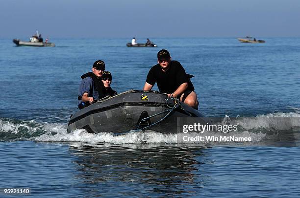 Crew members of the Canadian Navy vessel HMCS Athabaskan step ashore in the city of Leogane on January 21, 2010 in Leogane, Haiti. Forces from the...