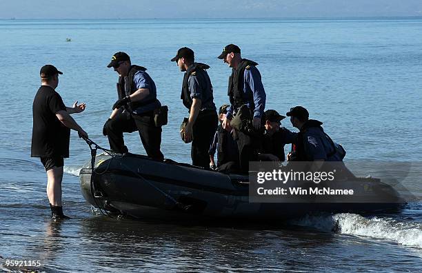 Crew members of the Canadian Navy vessel HMCS Athabaskan step ashore in the city of Leogane on January 21, 2010 in Leogane, Haiti. Forces from the...