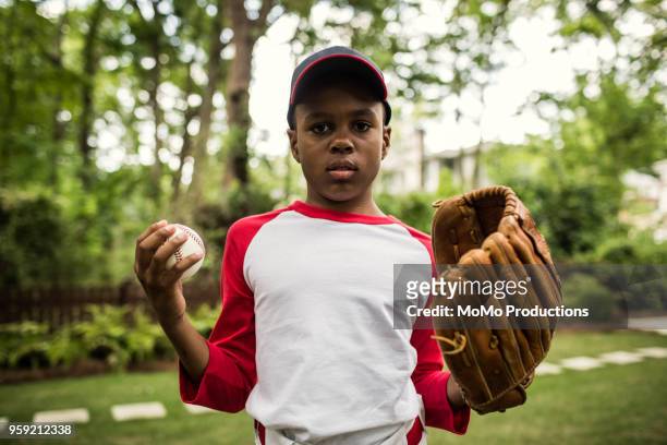 portrait of boy in baseball uniform outdoors - basebollhandske bildbanksfoton och bilder