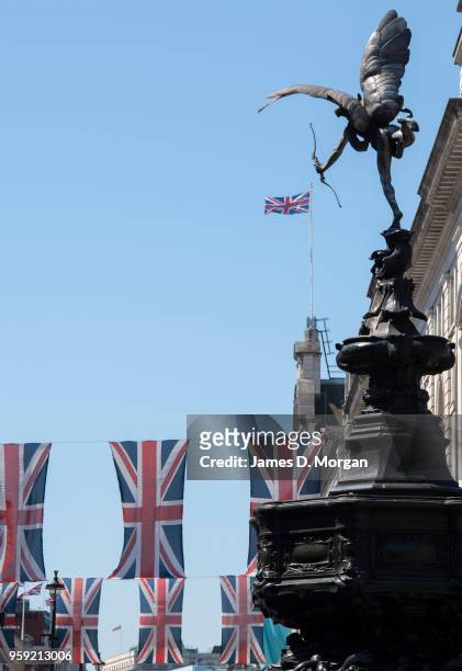 Union Jack flags fly in the sunshine with the statue of Eros in Piccadilly Circus on May 15, 2018 in London, England. The Royal Wedding between...