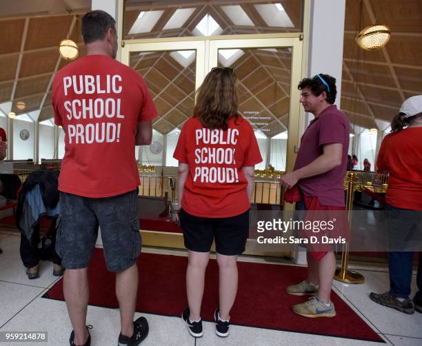 Advocates for teachers wait outside the North Carolina Senate doors to be allowed in on opening day of the General Assembly on May 16, 2018 in...