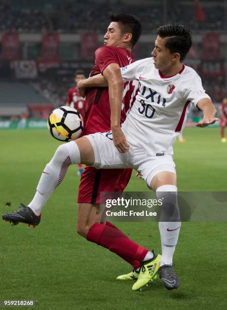 Yu Hai of Shanghai SIPG and Hiroki Abe of Kashima Antlers in action during the AFC Champions League Round of 16 match between Shanghai SIPG v Kashima...