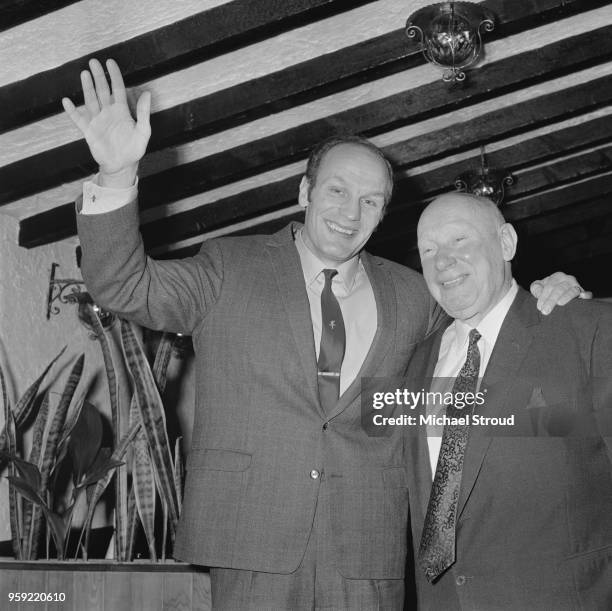 English heavyweight boxer Henry Cooper pictured on left with his manager Jim Wicks in London on 2nd December 1970. Cooper has just been informed that...