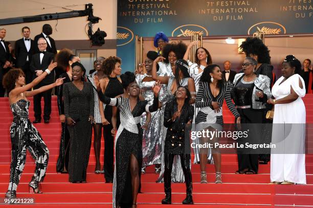 Authors of the book "Noire N'est Pas Mon Métier" dance on the stairs at the screening of "Burning" during the 71st annual Cannes Film Festival at...