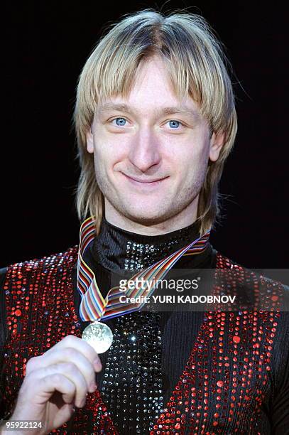 The winner, Russia's Olympic champion Yevgeny Plushenko, poses during the medal ceremony of Men's event at the 2010 European Figure Skating...