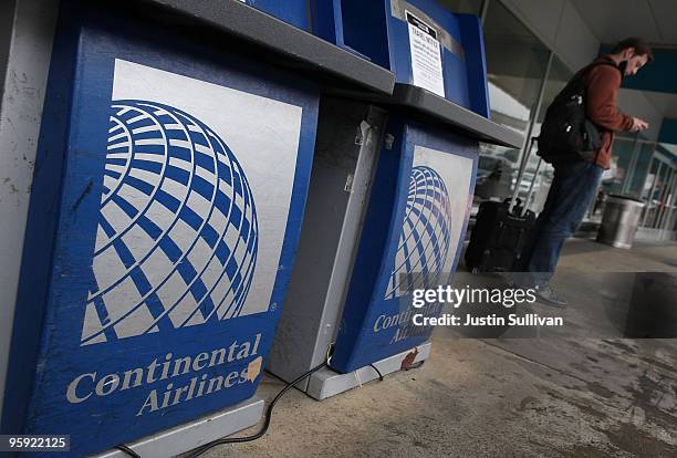 Traveler stands next to a Continental Airlines ticket counter at San Francisco International Airport January 21, 2010 in San Francisco, California....