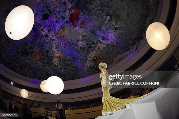 Model presents a creation under the Spanish artist Miquel Barcelo's ceiling painting as part a Biodiversity fashion show at the European headquarters...