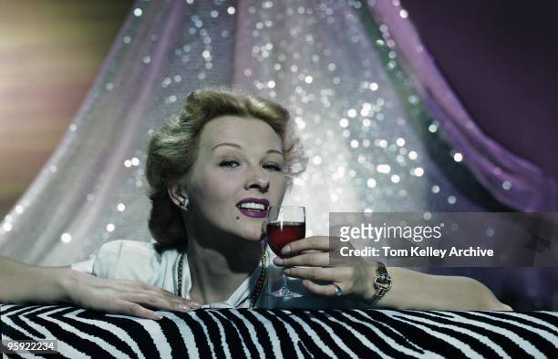 Gal with a wine glass on a zebra pattern in 1947.