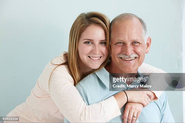 portrait of older man and young woman - moving down to seated position stock pictures, royalty-free photos & images